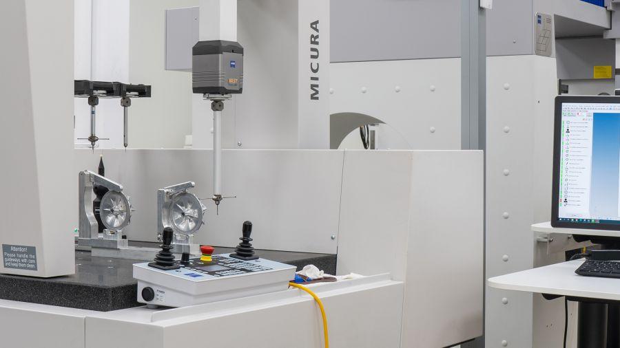 An optical sensor scans a part that is positioned on a measuring fixture.