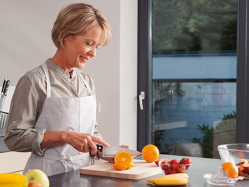 As a preventive measure of cataracts, a woman is preparing healthy food.