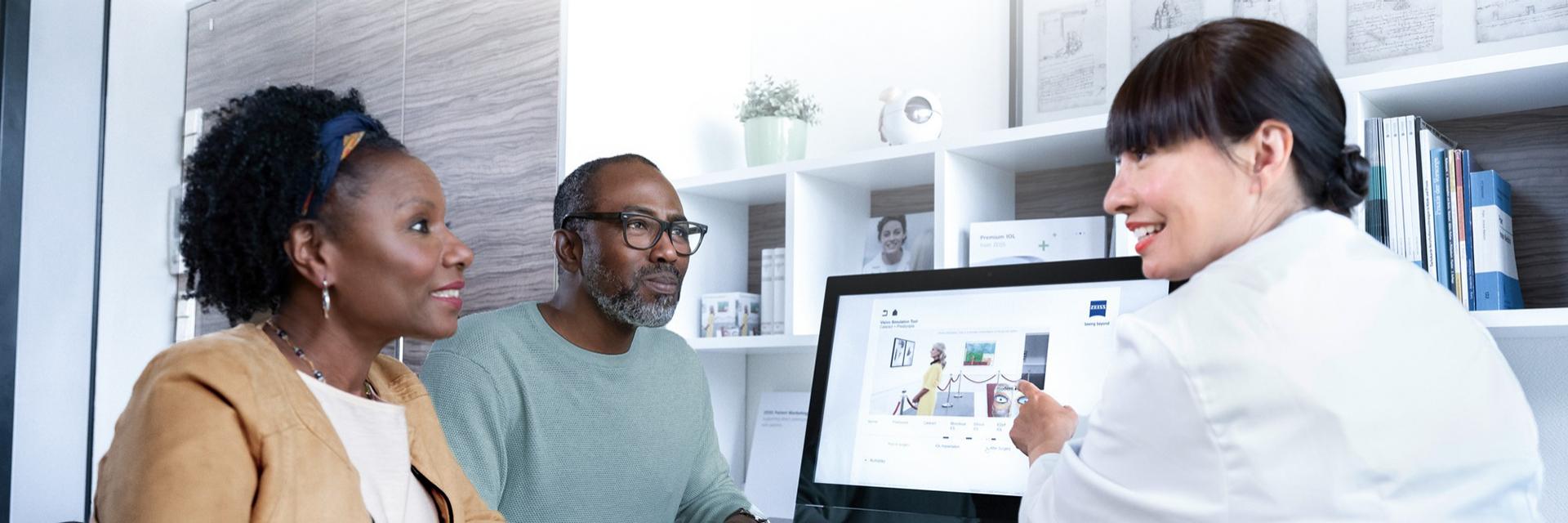 Doctor explaining a cataract lens to a patient.