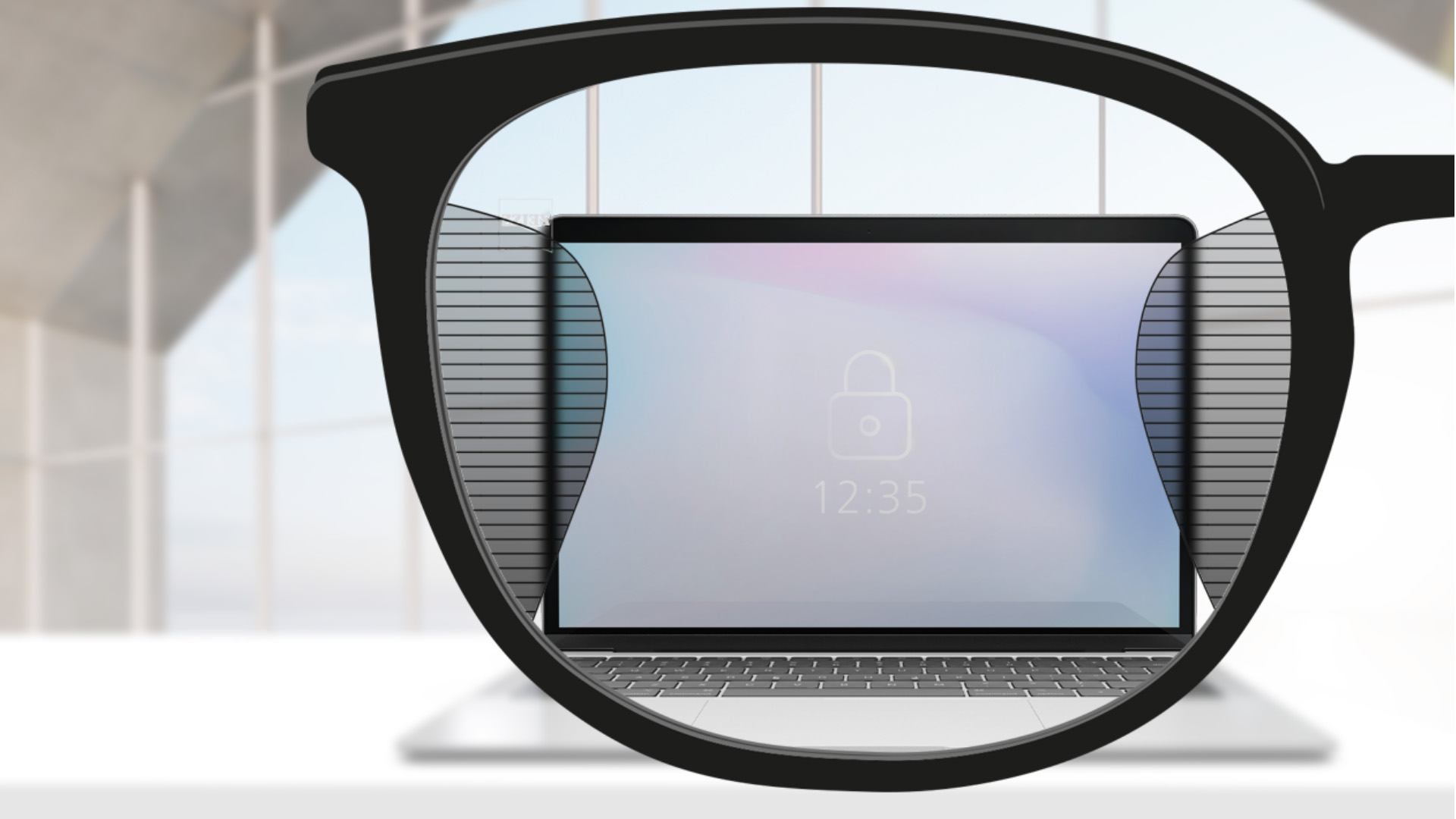 A point of view image with ZEISS Office lenses with a computer screen in the center of the lens and slim blurry plots left and right.